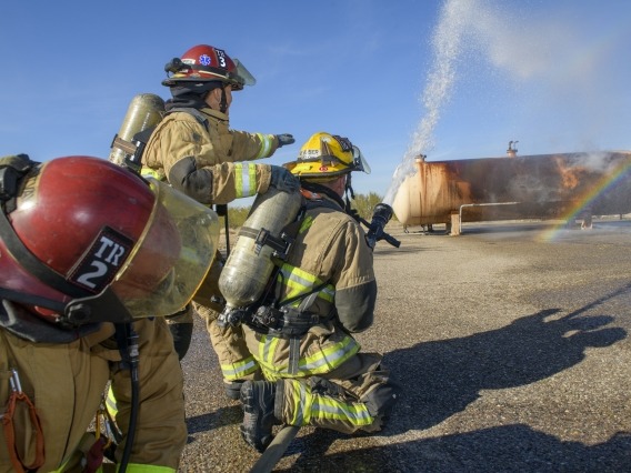 firefighters spraying a fire with water